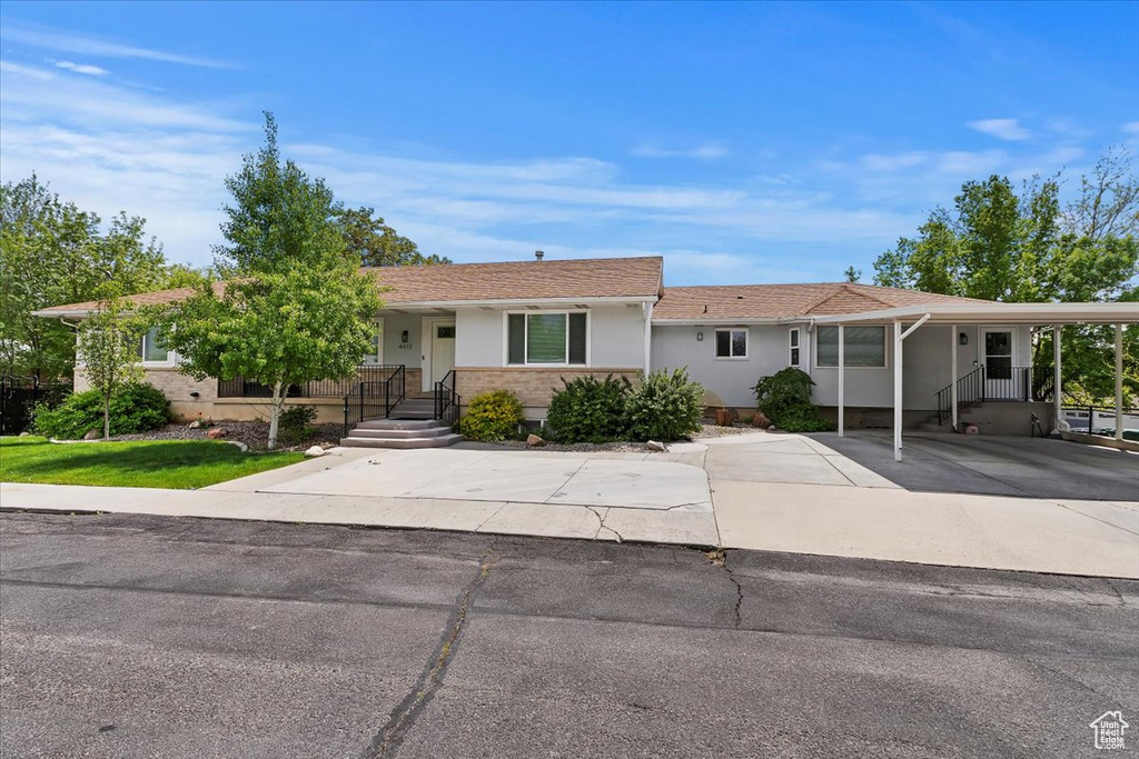 Single story home with stucco siding and concrete driveway