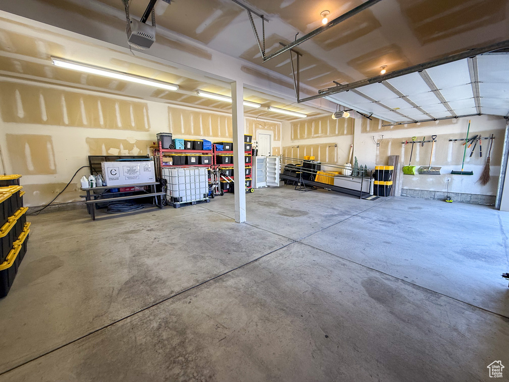 Garage featuring a garage door opener and a workshop area