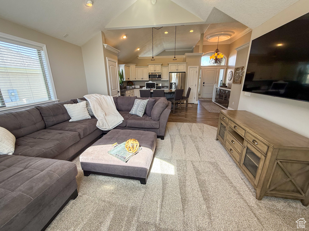 Living area with recessed lighting, light wood finished floors, and lofted ceiling