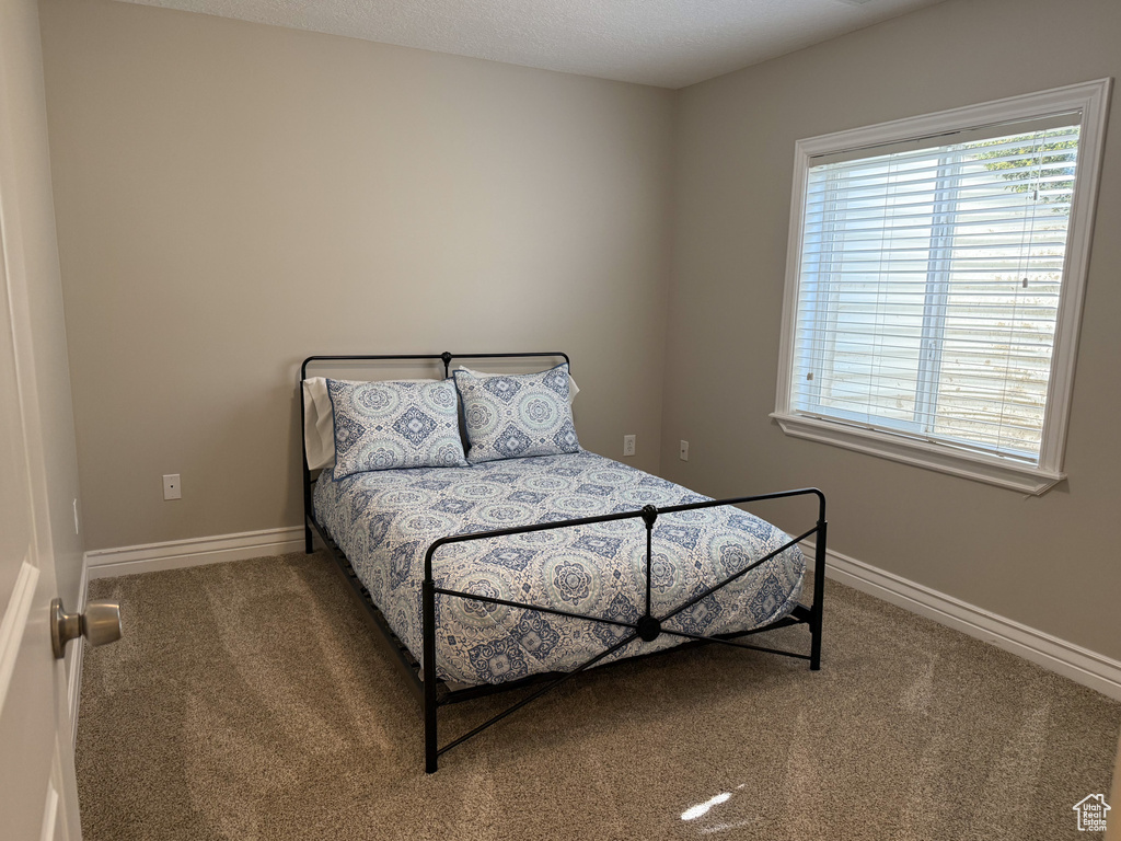 Carpeted bedroom with baseboards