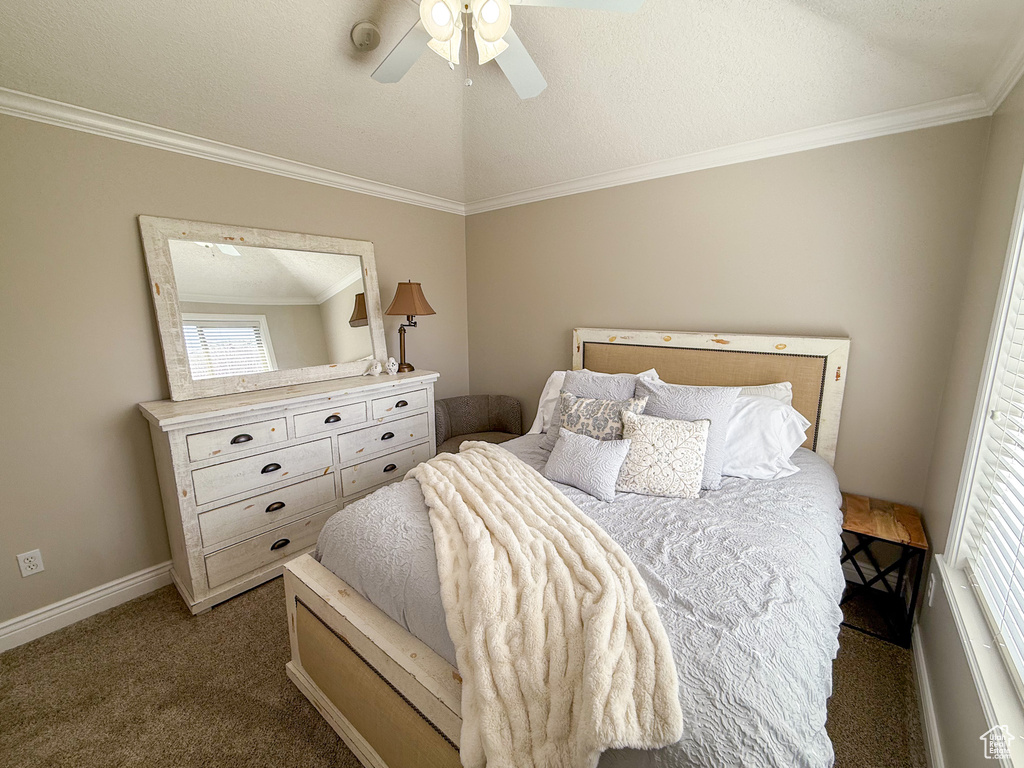 Carpeted bedroom with baseboards, ornamental molding, and ceiling fan