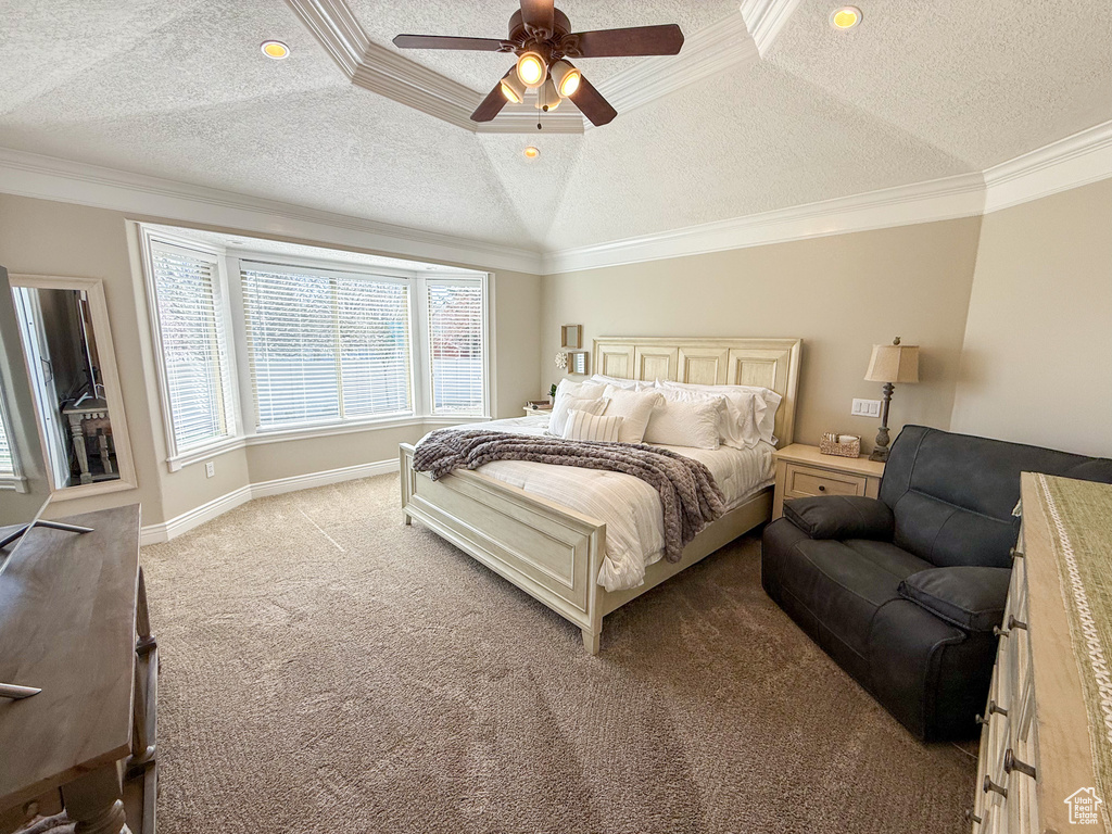 Carpeted bedroom with crown molding, baseboards, a ceiling fan, and a textured ceiling