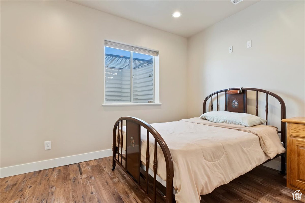 Bedroom with baseboards, recessed lighting, and wood finished floors