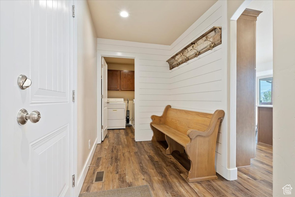 Mudroom with visible vents, recessed lighting, wood finished floors, and washing machine and clothes dryer