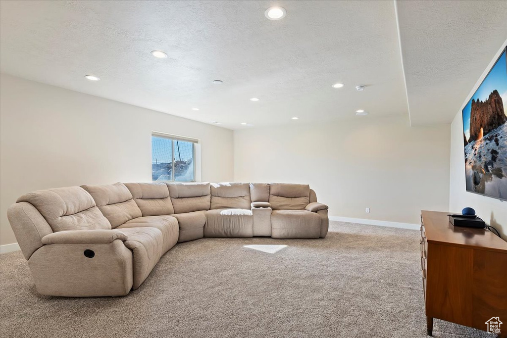 Living room featuring baseboards, carpet, recessed lighting, and a textured ceiling