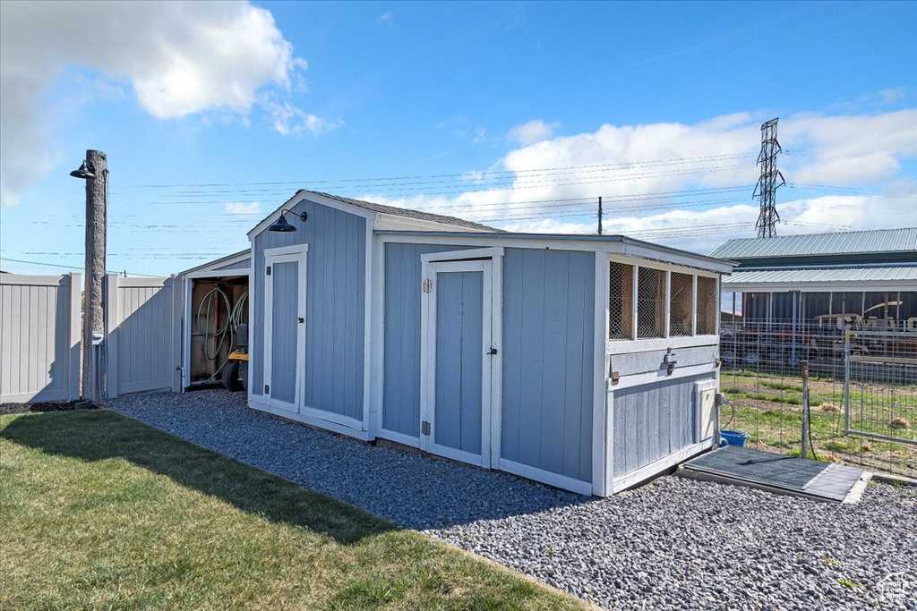 View of shed featuring fence