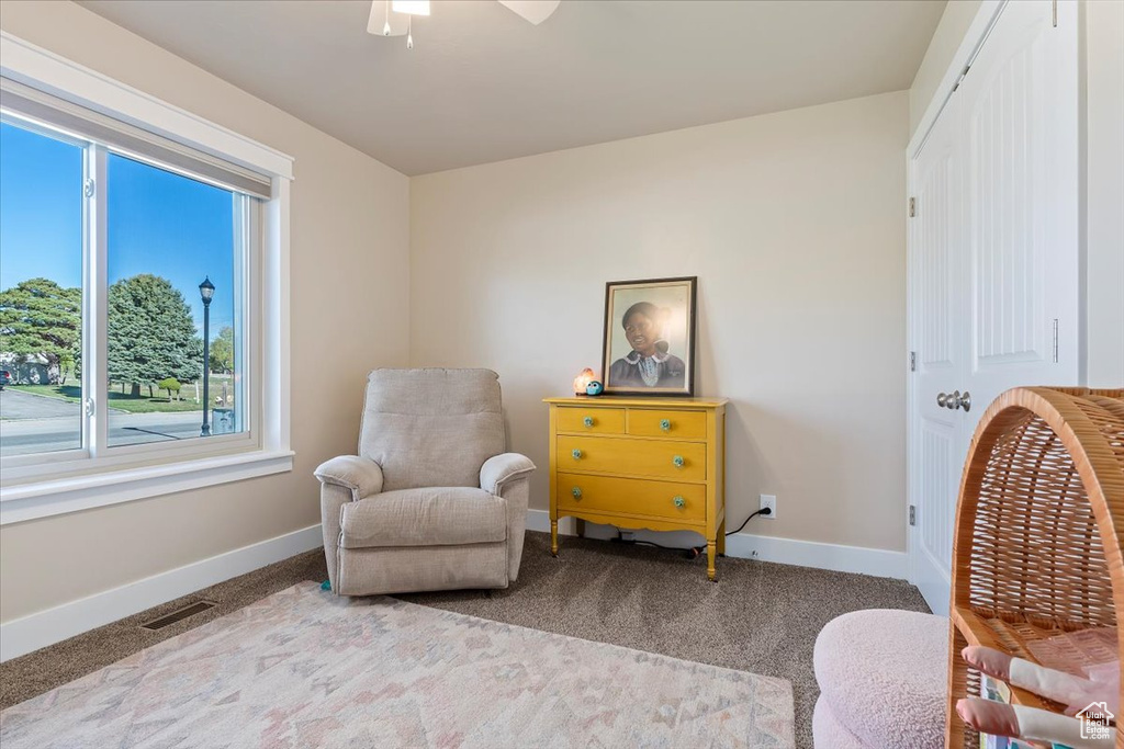 Sitting room featuring baseboards, ceiling fan, carpet flooring, and visible vents