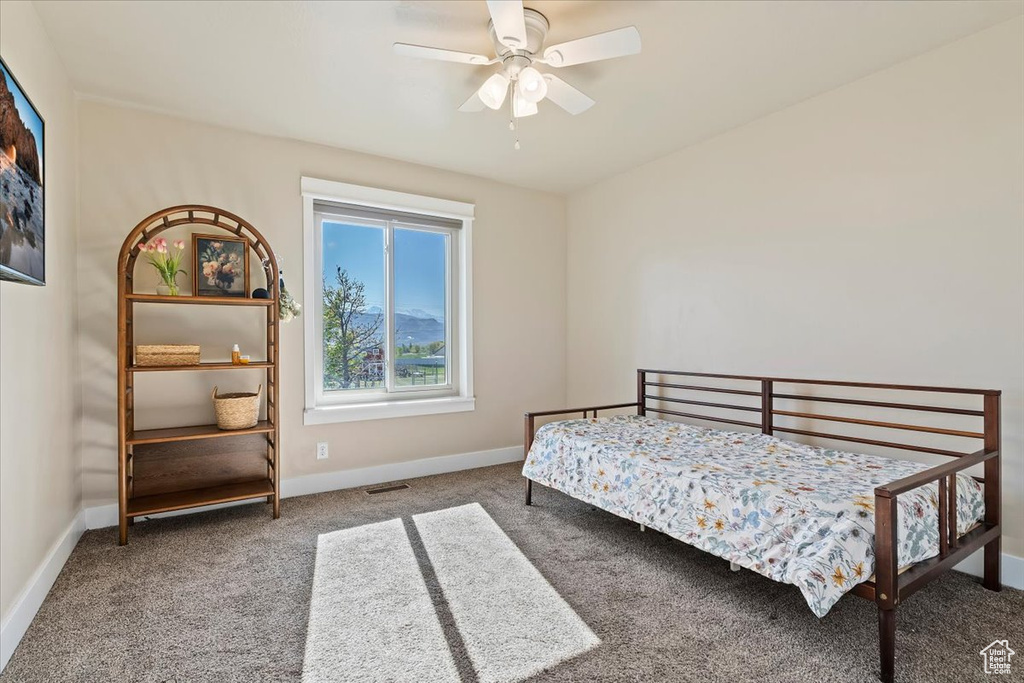 Bedroom featuring baseboards, carpet, and a ceiling fan