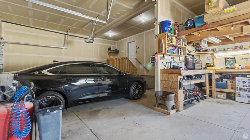 Garage with a garage door opener and a workshop area