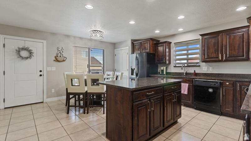 Kitchen with dishwasher, stainless steel refrigerator with ice dispenser, recessed lighting, a sink, and light tile patterned floors