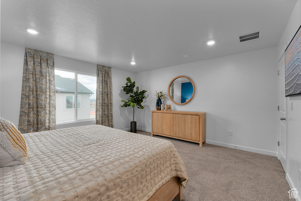 Bedroom featuring baseboards, light colored carpet, recessed lighting, and visible vents