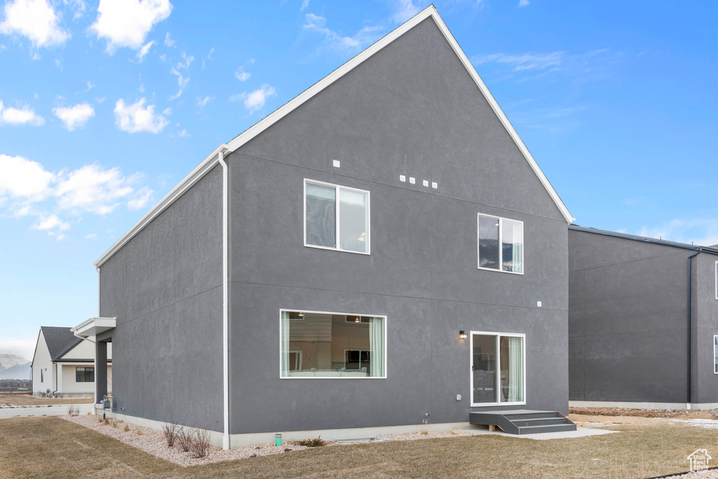 Rear view of property with stucco siding
