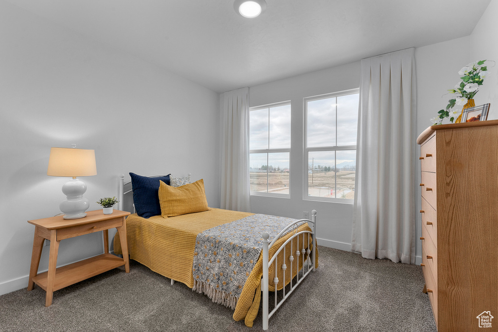 Carpeted bedroom featuring baseboards