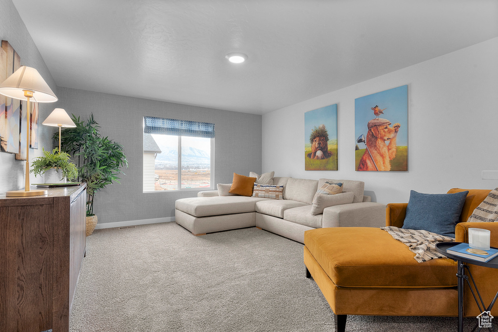 Living area featuring baseboards and carpet