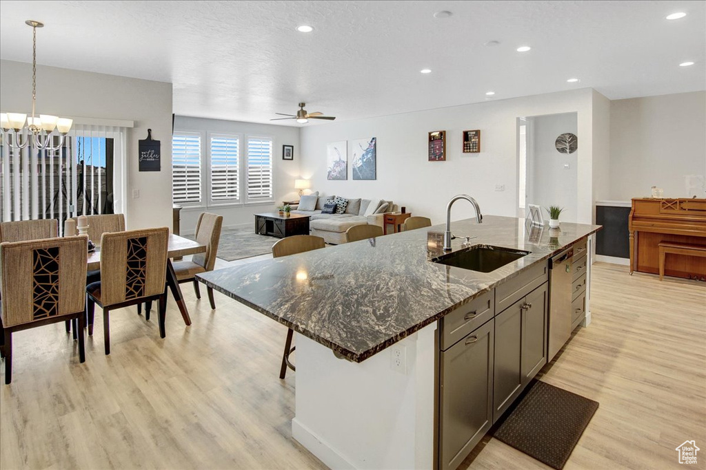 Kitchen featuring a sink, recessed lighting, light wood-type flooring, and dishwasher