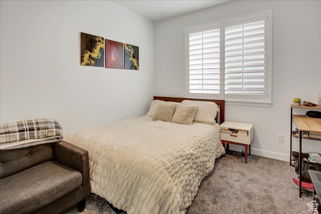 Bedroom with carpet floors and baseboards