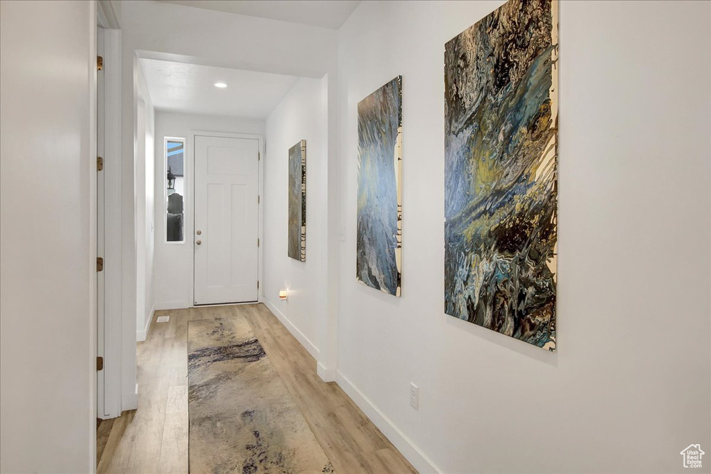 Hall with baseboards, recessed lighting, and light wood-style flooring
