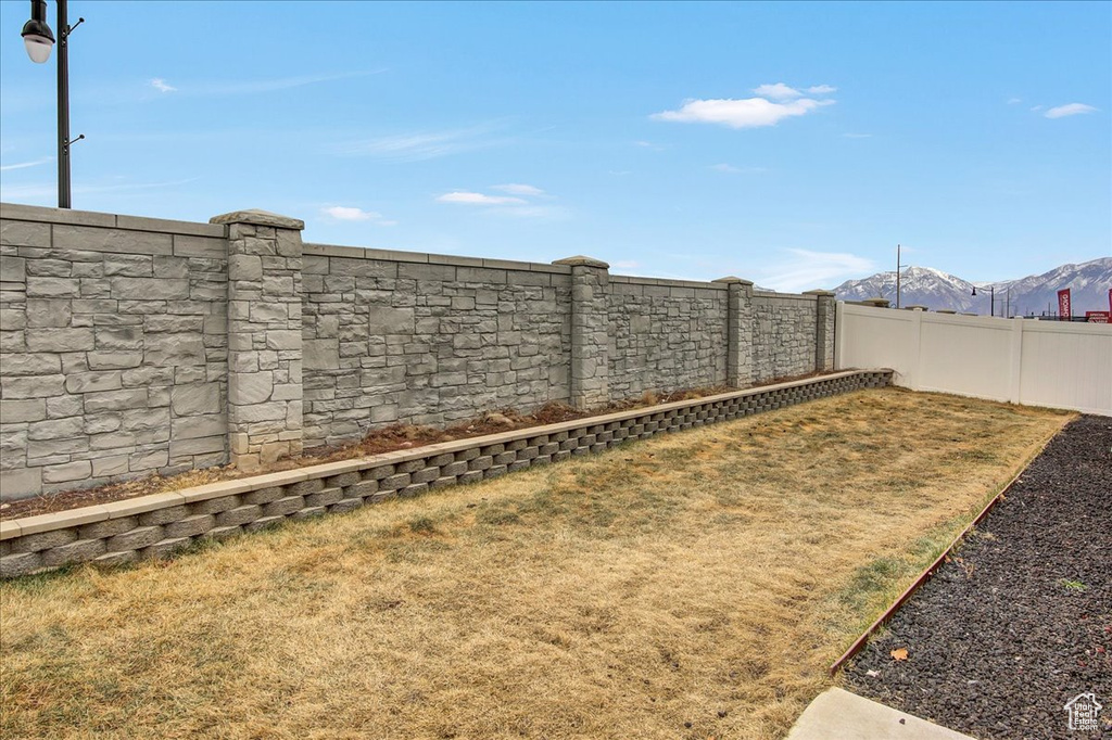 View of yard with a fenced backyard and a mountain view