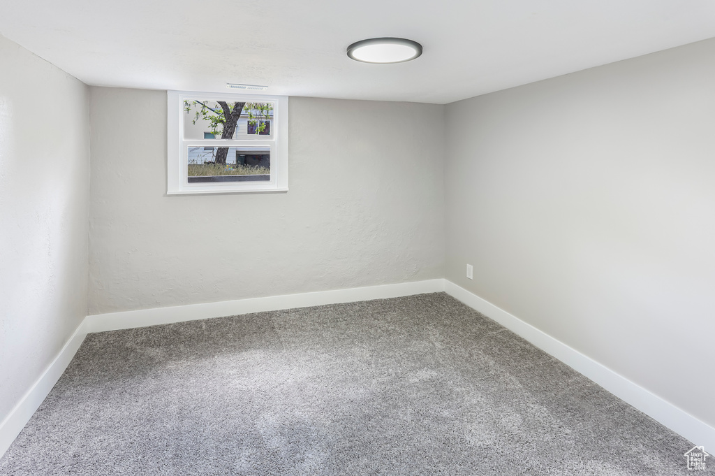 Below grade area featuring carpet floors and baseboards