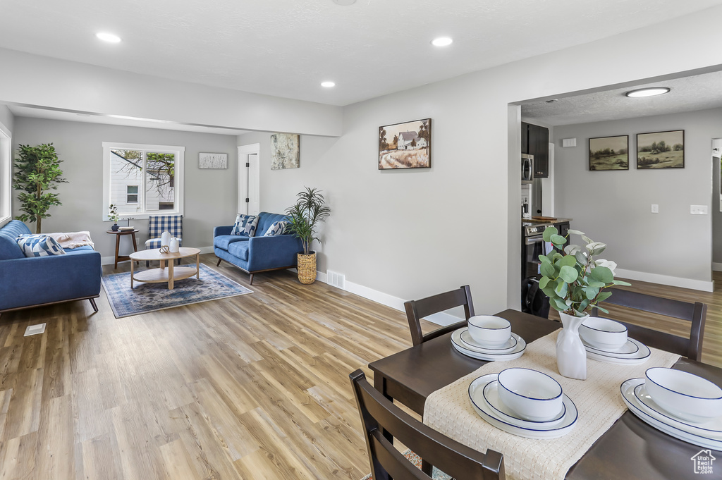 Dining room with baseboards, recessed lighting, and light wood-style flooring