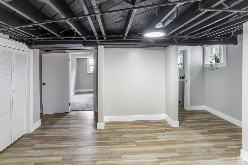 Basement featuring baseboards and light wood-style floors