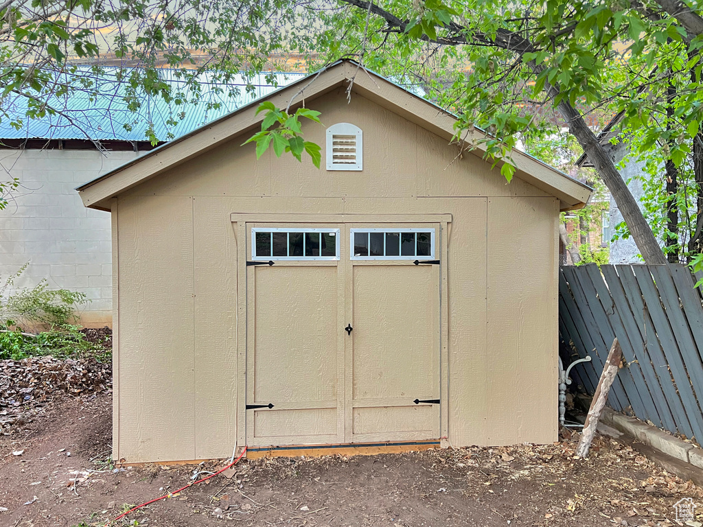 View of shed featuring fence