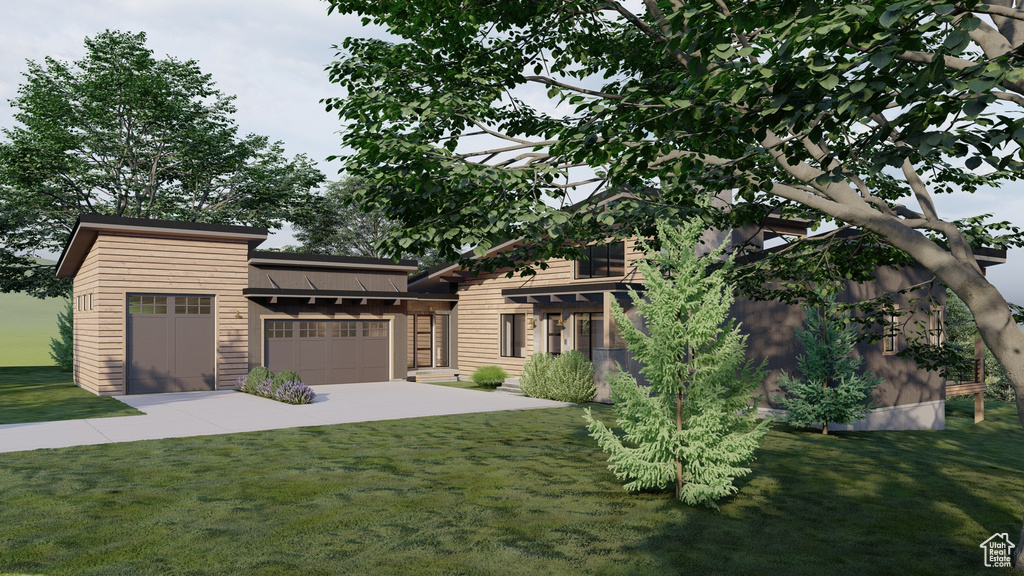 Prairie-style home with a garage, driveway, and a front yard