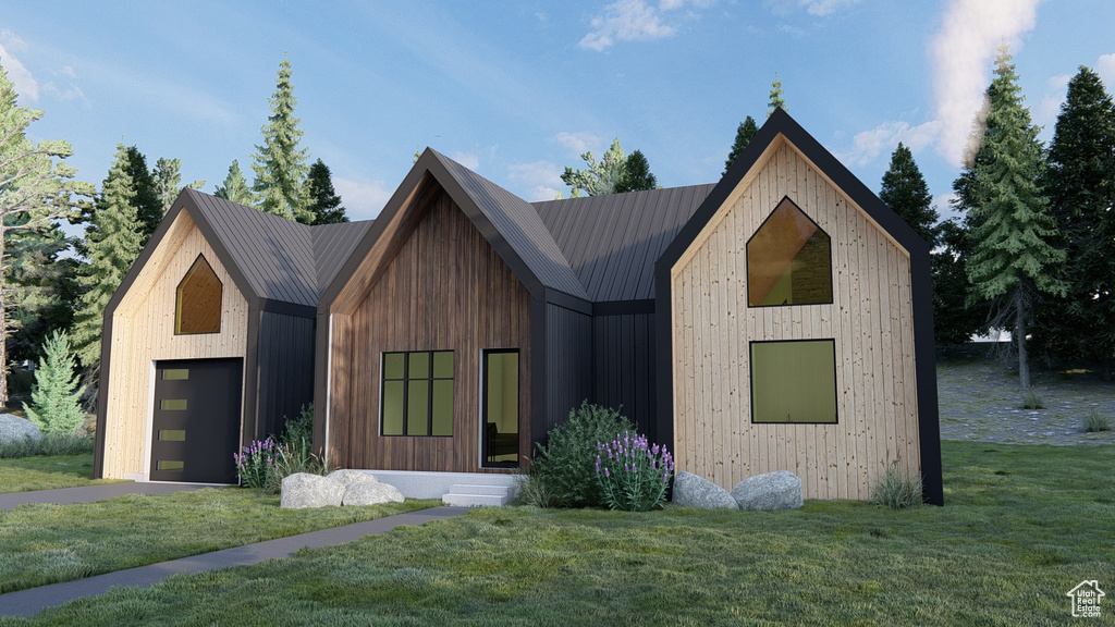 Modern farmhouse style home featuring a front lawn