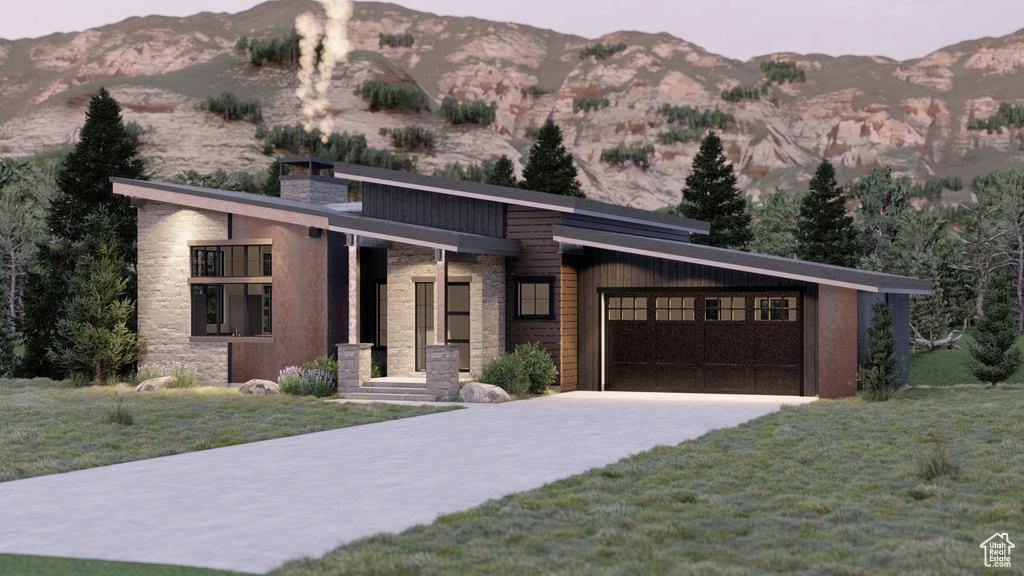 View of front of property featuring a garage, a front yard, stone siding, a chimney, and a mountain view