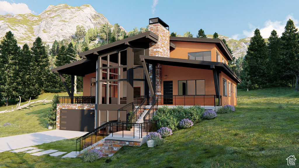View of front of home with a chimney, stairway, a mountain view, a front lawn, and concrete driveway