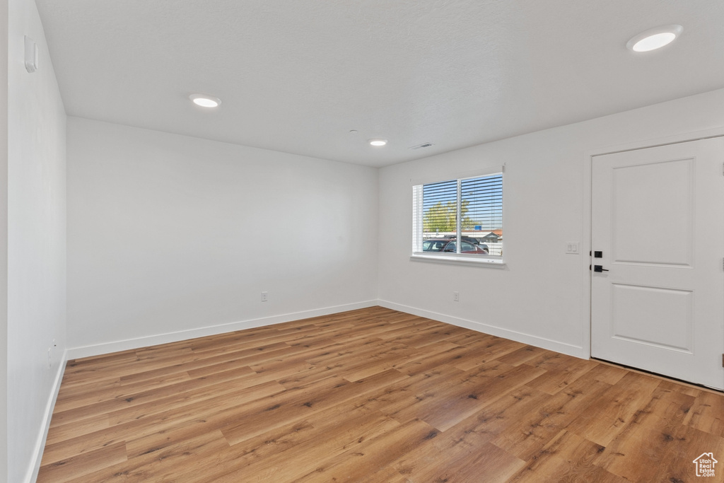 Unfurnished room featuring recessed lighting, baseboards, and light wood-style floors