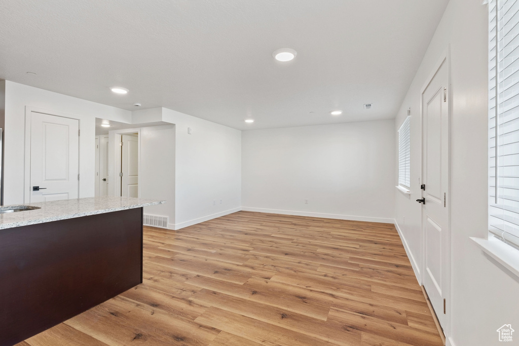 Interior space with light wood-type flooring, recessed lighting, baseboards, and visible vents