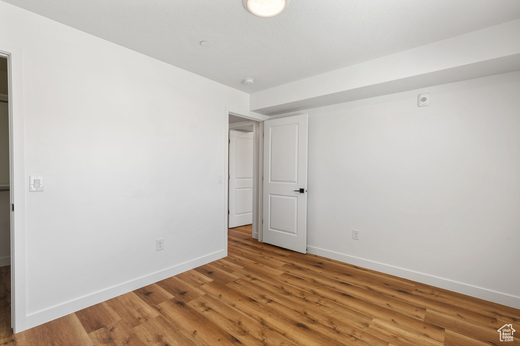 Unfurnished bedroom with baseboards and light wood-type flooring