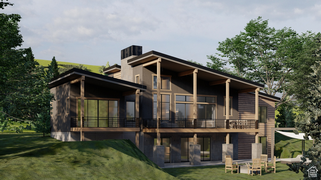 Rear view of house with a lawn, a patio, a chimney, and a sunroom