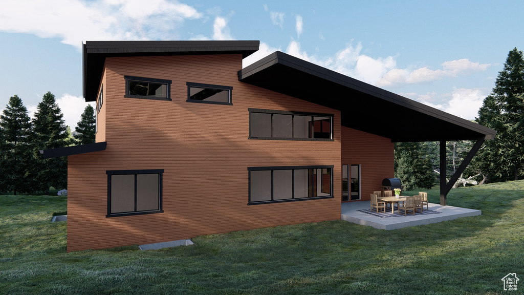 Rear view of property featuring a lawn and a patio