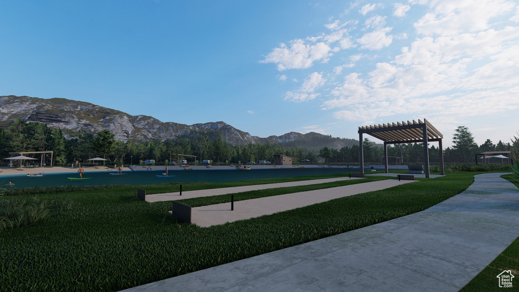 View of property's community featuring a yard, a pergola, and a mountain view