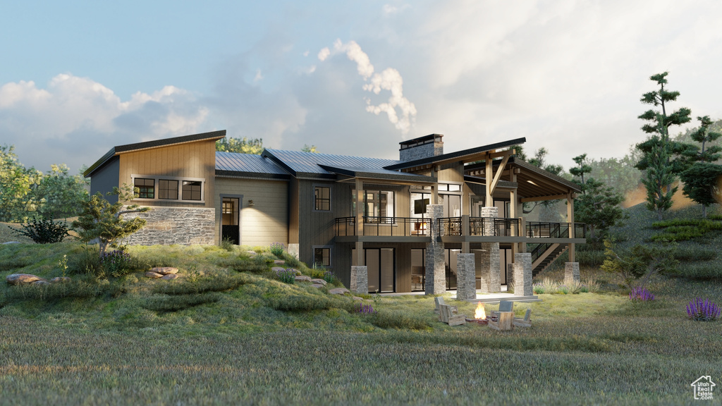 Back of house with a wooden deck, stone siding, a chimney, metal roof, and stairway