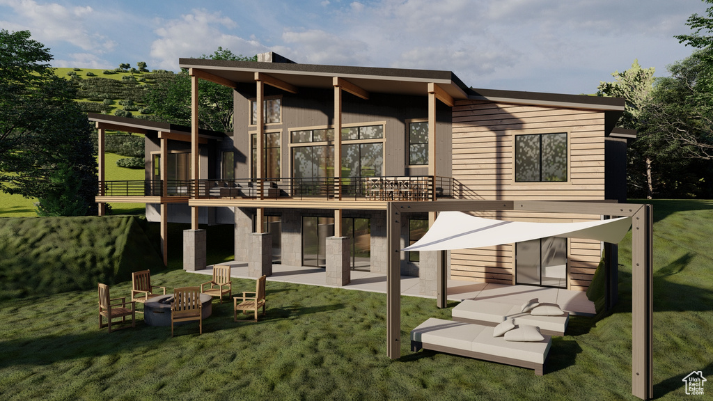 Rear view of house with a yard, a patio, a deck, and an outdoor fire pit