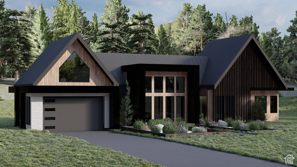 View of front facade featuring a garage, a front lawn, and driveway