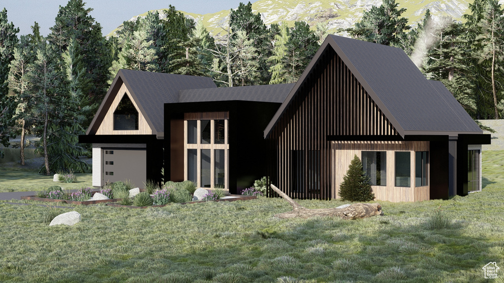 Modern farmhouse style home featuring a garage, a mountain view, and a front yard