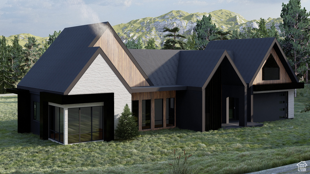 View of front of property featuring a mountain view, a front lawn, and stone siding