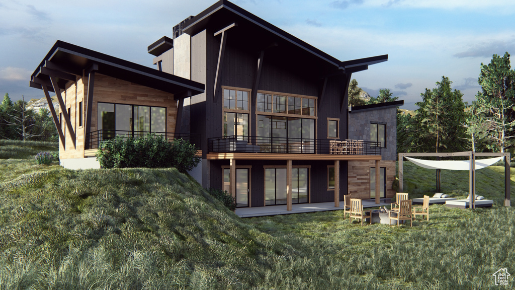 Back of house with a lawn and a patio area