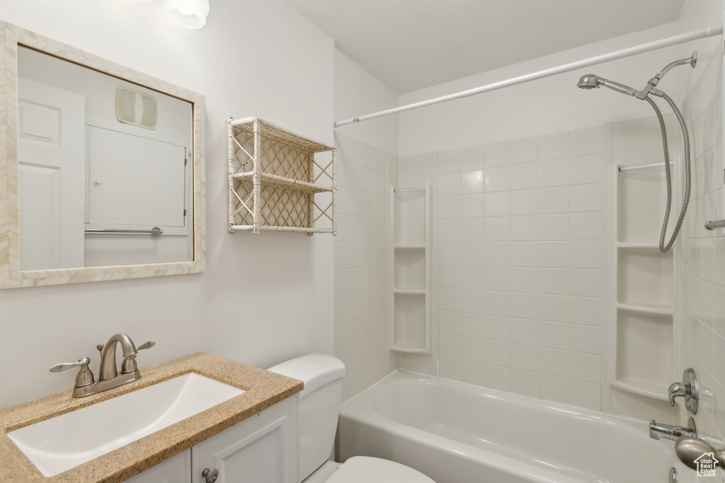 Bathroom featuring toilet, bathing tub / shower combination, and vanity