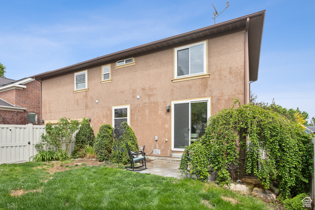 Back of property featuring stucco siding and a patio area