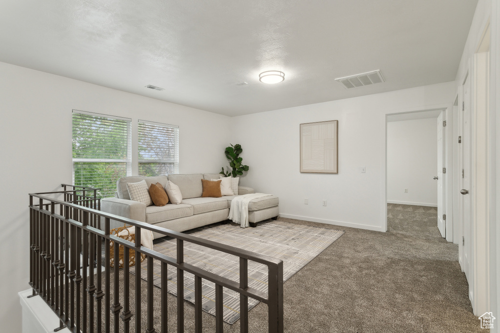 Carpeted living area with baseboards