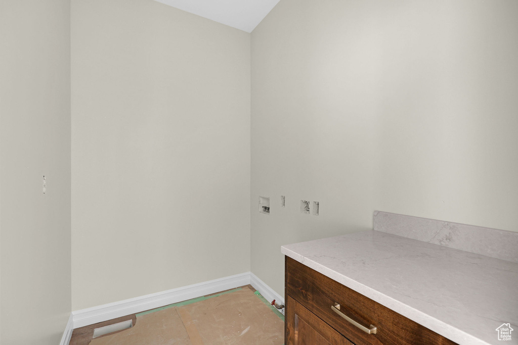 Clothes washing area with baseboards