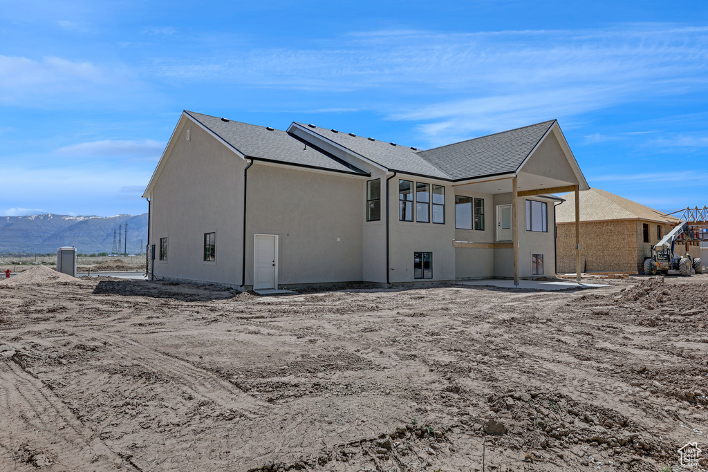 Back of property featuring stucco siding and a mountain view