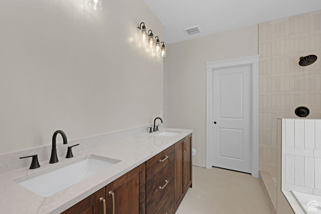 Full bath featuring a tile shower, double vanity, and a tub