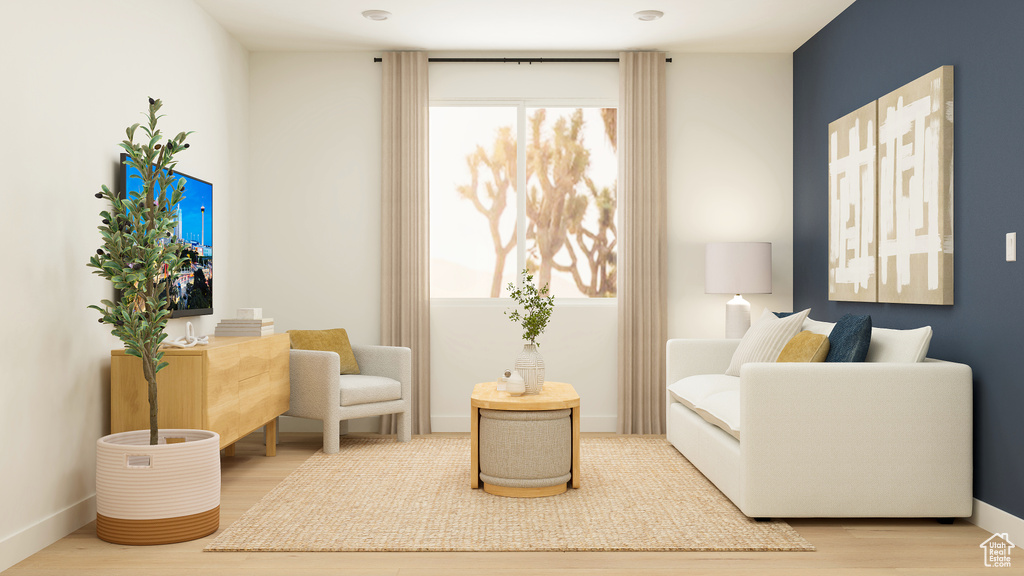 Living area featuring baseboards, plenty of natural light, and wood finished floors