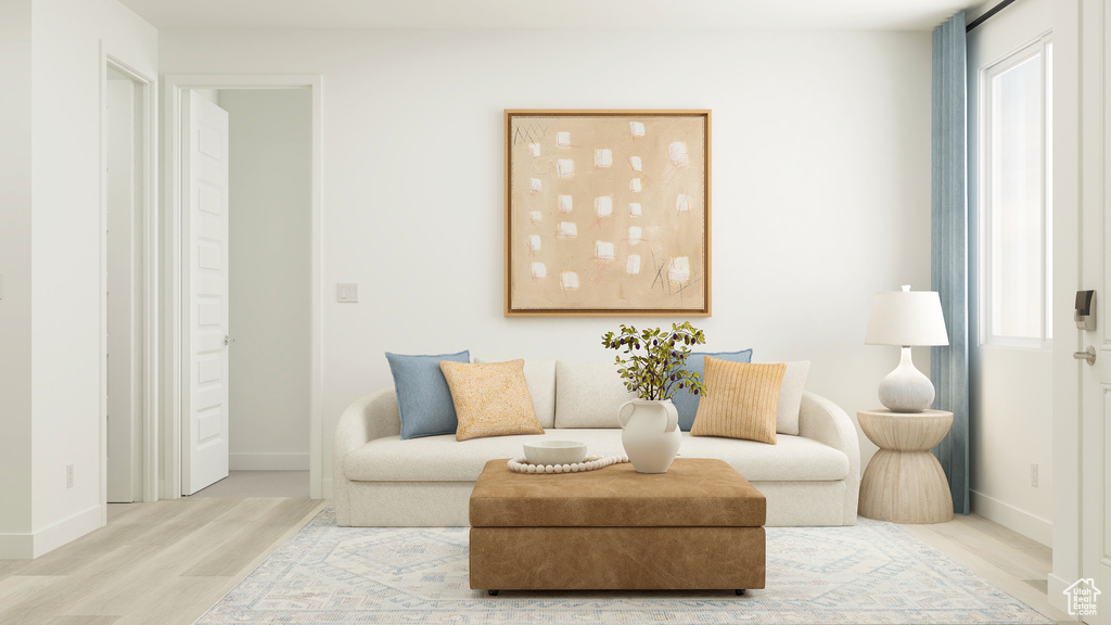 Living area featuring baseboards, wood finished floors, and a wealth of natural light